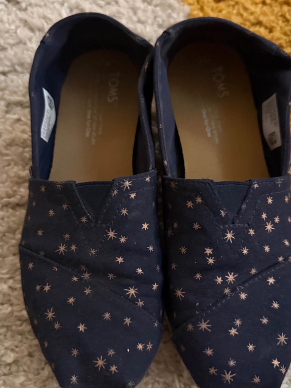 TOMS Navy Canvas Slip-Ons with Rose Gold Star Print
